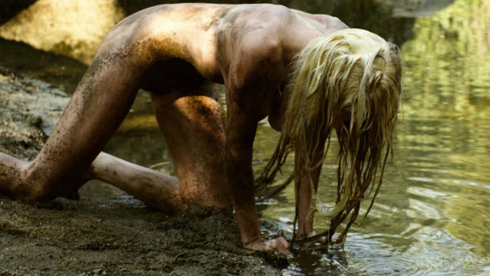 INTO THE MUD nude woman crawling in the water