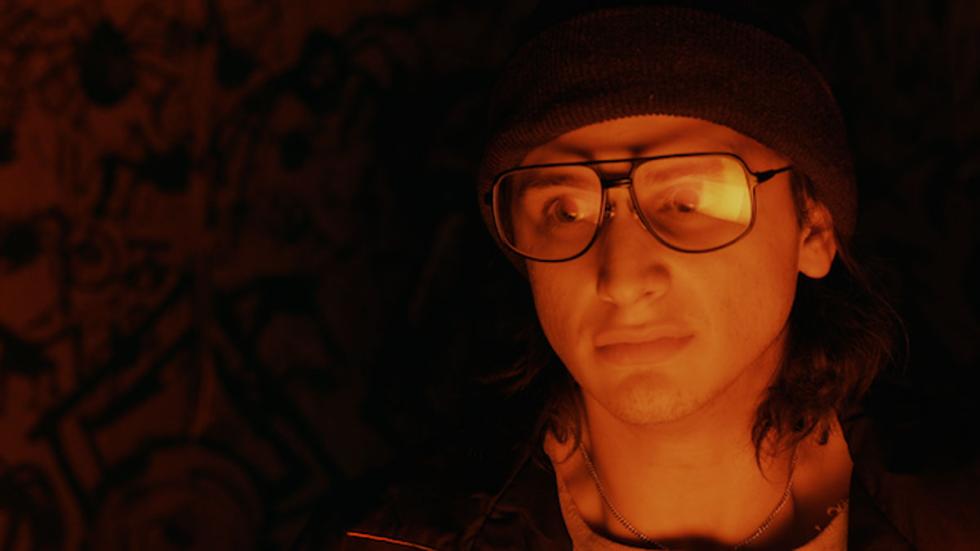 Itsy Bitsy Spiders young man with glasses and a hat looking on