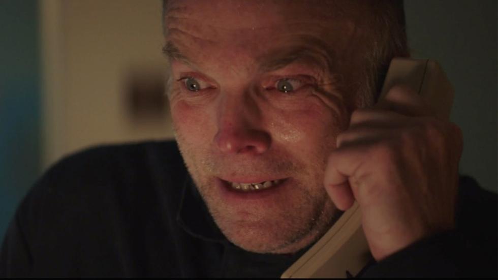 Teething film still John talking on the phone