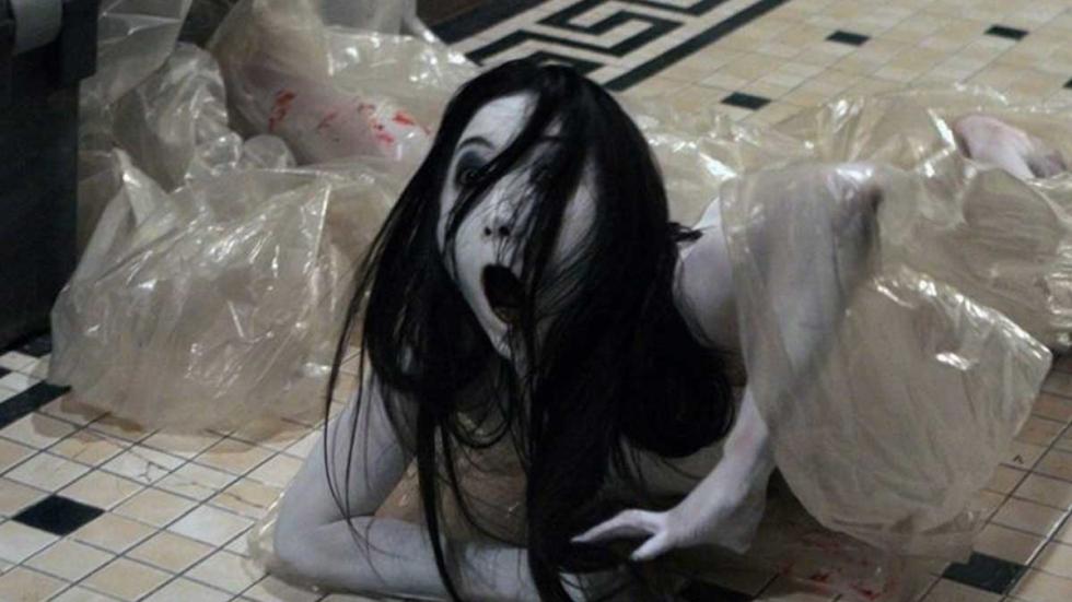 Ju-on: The Grudge female creature with long black hair crawls out of a plastic bag