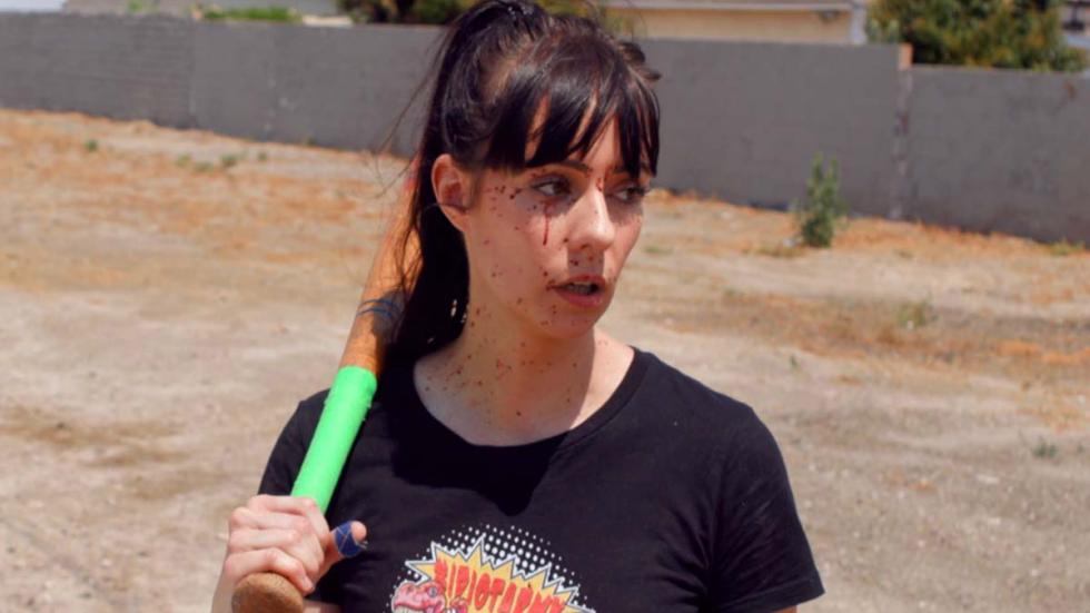 A Real Killjoy woman with a bat