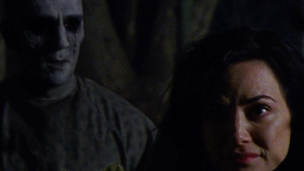 Lakeland film still of woman with creepy dead man behind her