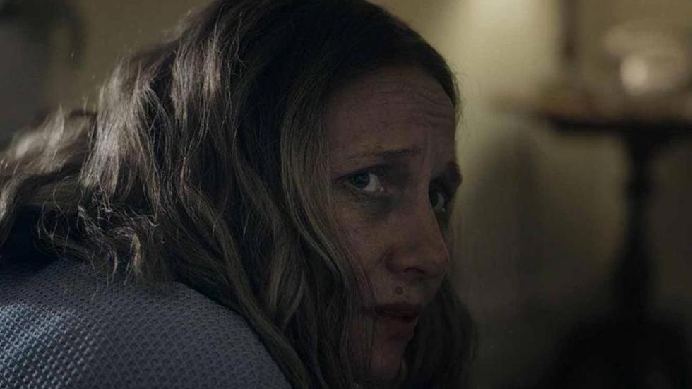Leach film still woman looking back in fear.