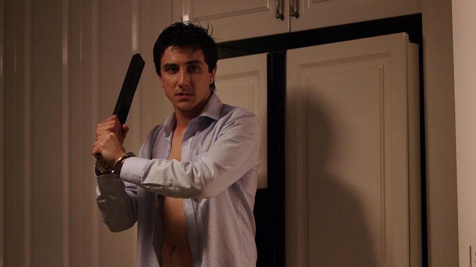 Liar Man holds a piece of wood for protection