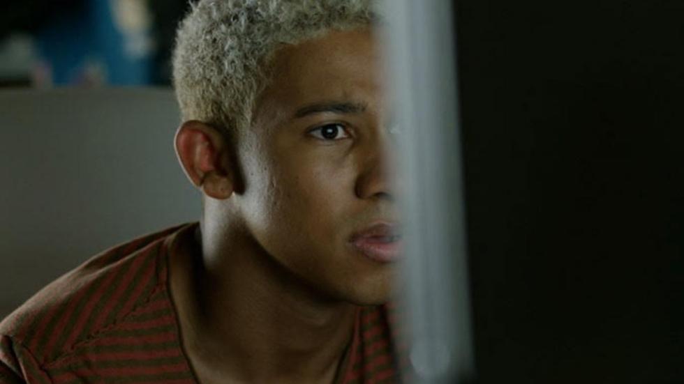 Like.Share.Follow film still man looks at computer screen