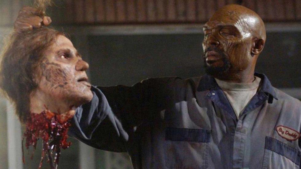 Land of the Dead a man holds a human head