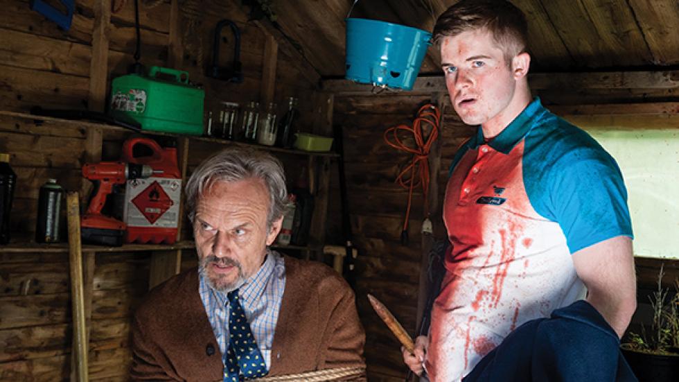 Let the Wrong One In film still one man tied up and another with a knife