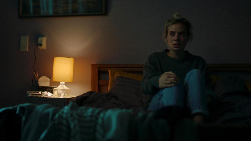 The Departure film still woman sitting on bed