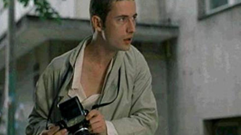Mimic: Sentinel A man holds a camera