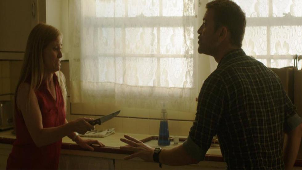 A Mother's Love film still woman holds a knife to her husband in the kitchen