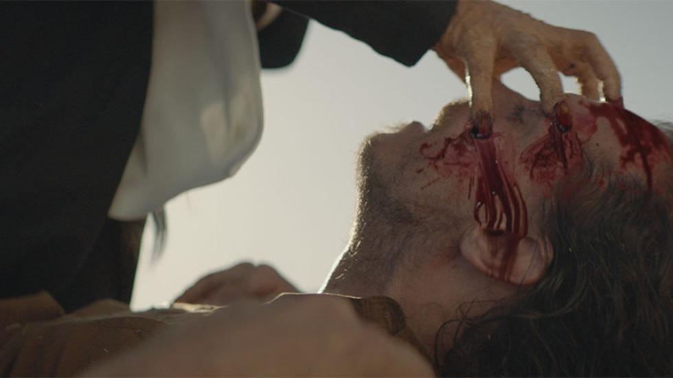 Nagual: The Sin Eater film still man puts fingers in other mans eyes