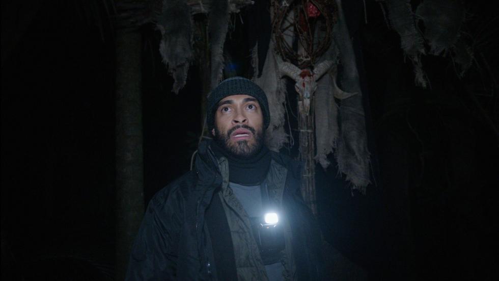 Man with a flashlight looks scared
