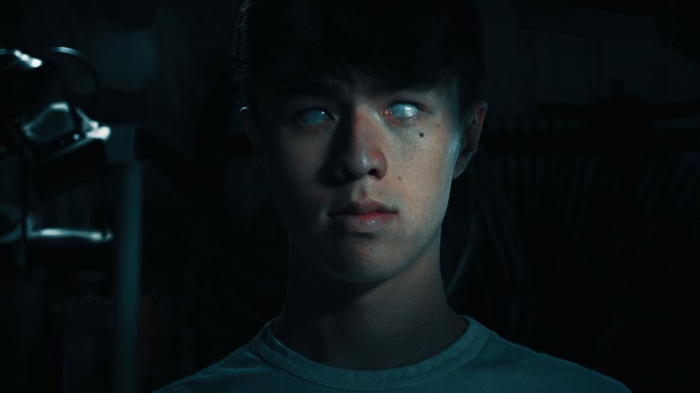 A young man stares with glossy eyes
