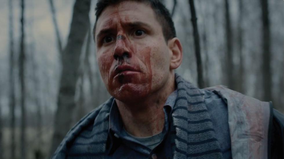 Never Tear Us Apart film still Man in woods with bloody face
