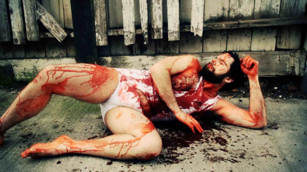 OK Monster film still bloodied man laying on the ground in his underwear.