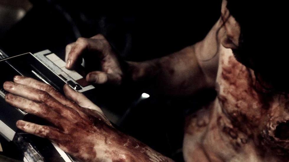 Other man with blood on him writes