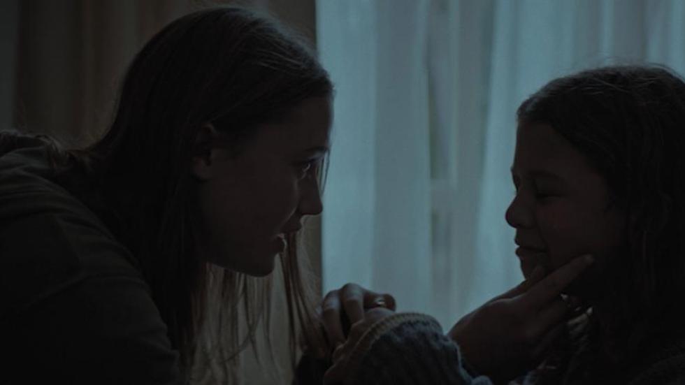 Shielded film still two young sisters talking to each other