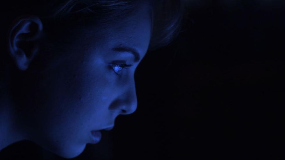 Phoebe woman in the dark stares at something