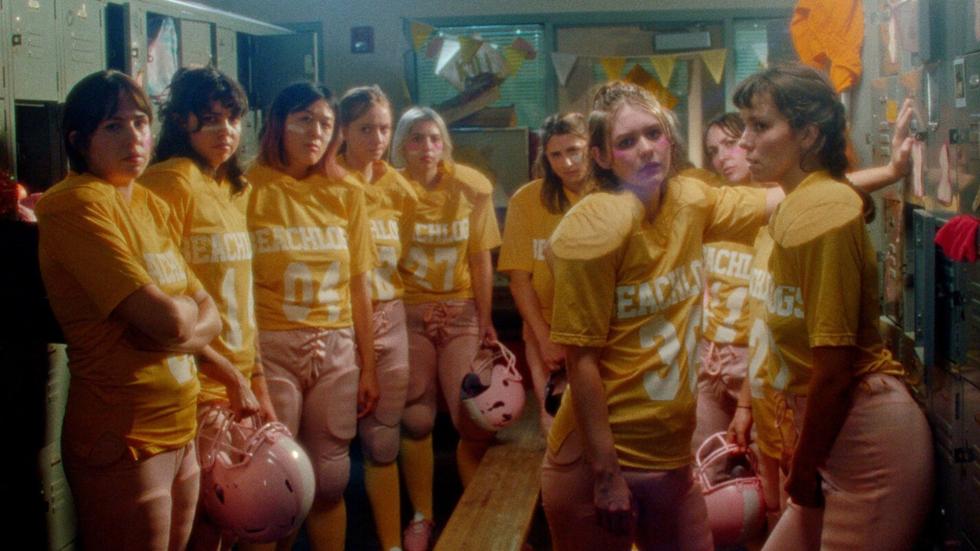 female football team stands in locker room