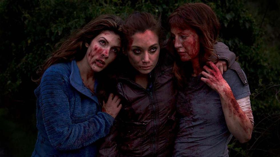 Quarries film still three bloodied women helping each other