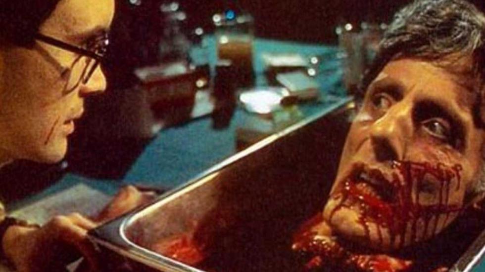 Re-Animator Dr. Herbert West looks at the living head in a pan