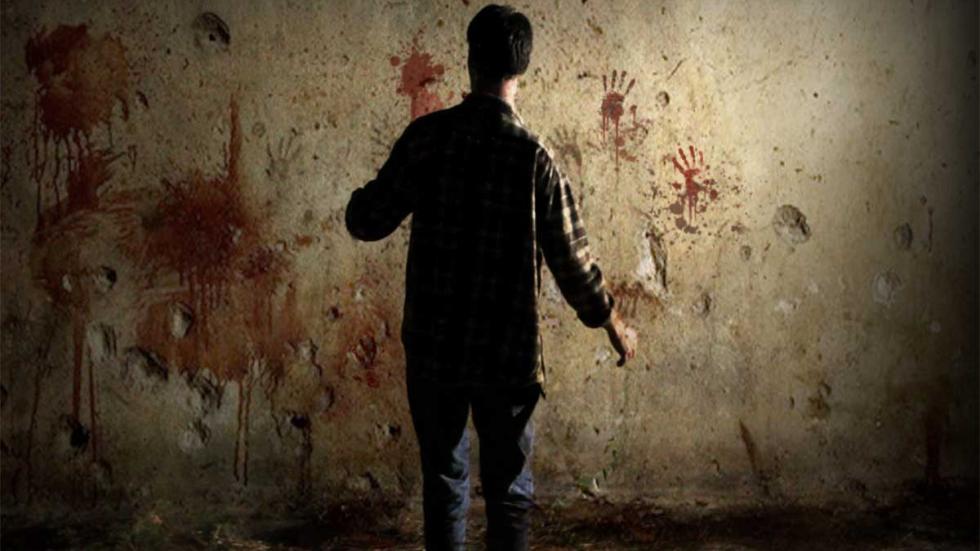 Recollection man looks at a bloody wall