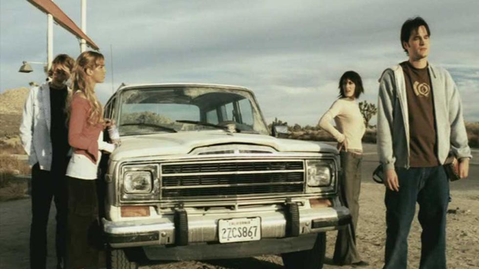 Reeker five students stand around their car when the highway is closed