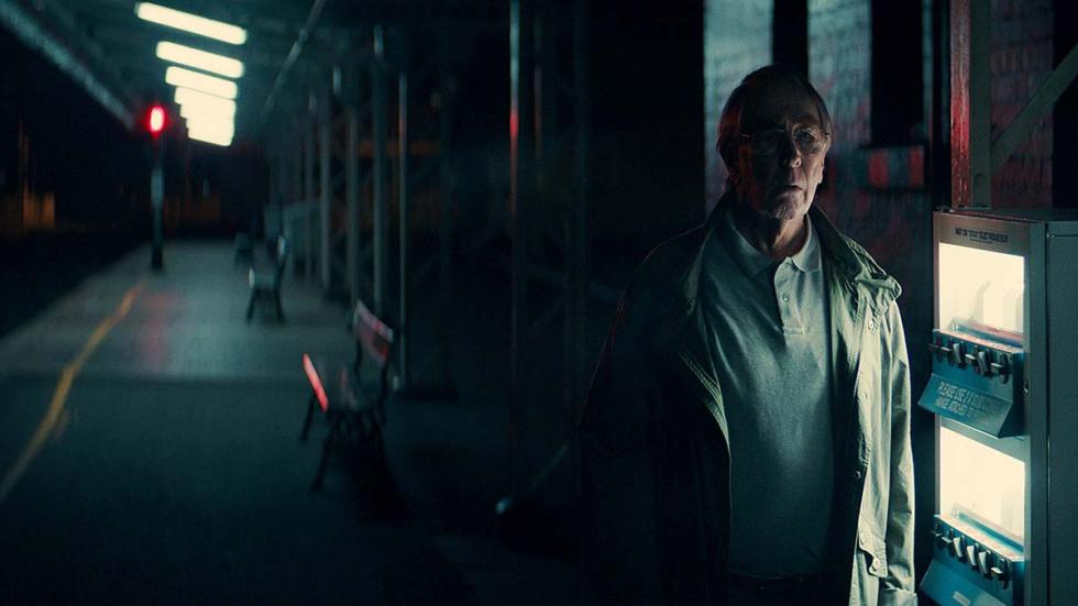 REFORMED film still man standing in a subway station