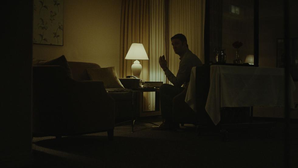 Regret film still man sitting in the dark