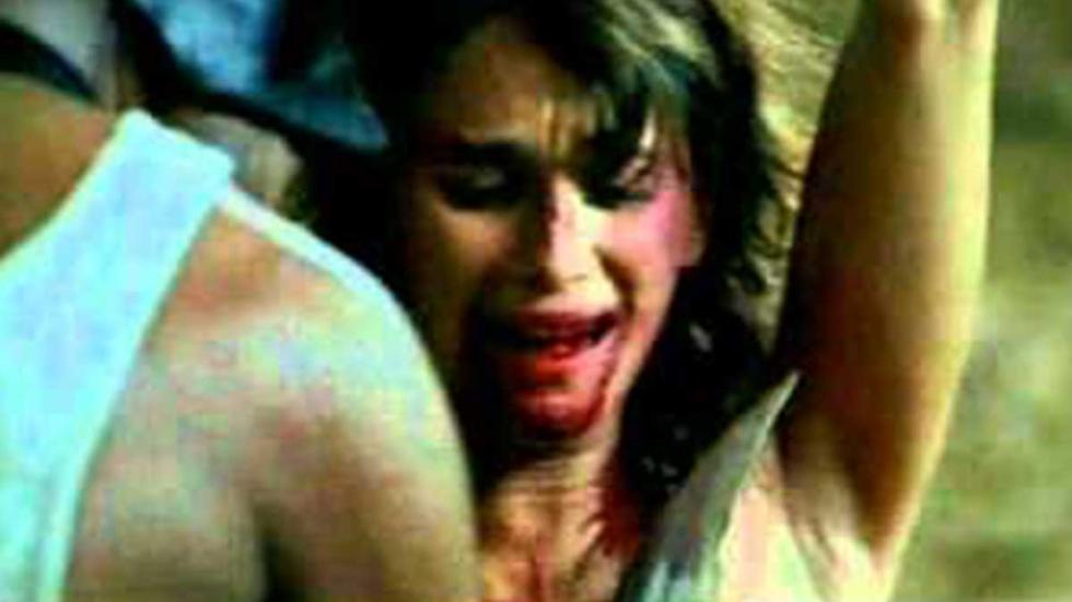 Rojo Sangre A bloodied faced woman is tied up in fear