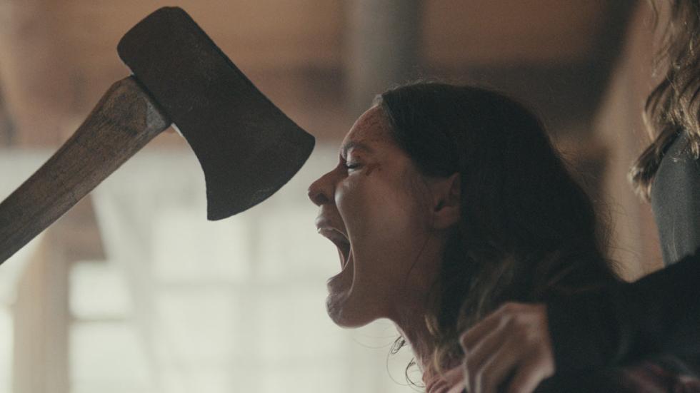 The Rule of Three film still woman with an axe almost in her face