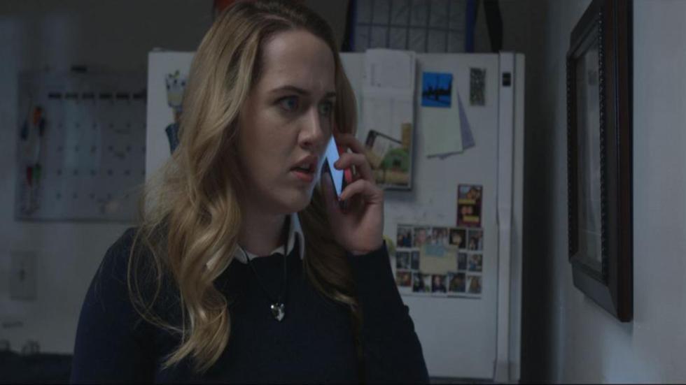 Feeding Time film still woman looks worried speaking on the phone