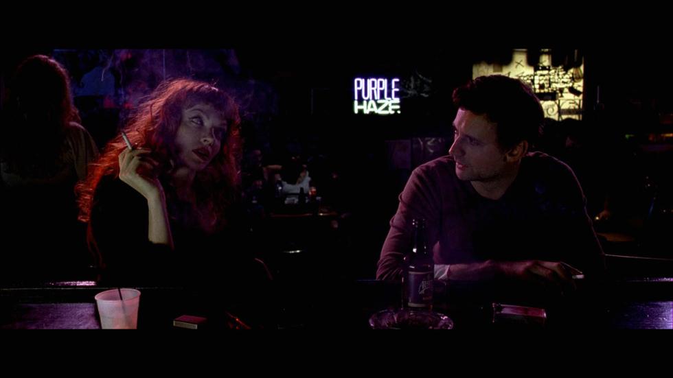 Schism man and woman sit at a bar