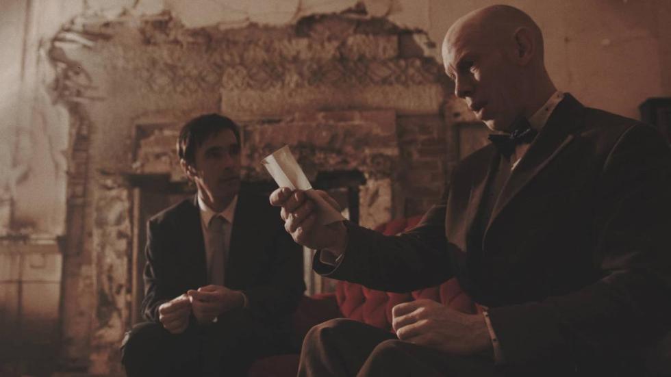 Crave film still man looks at a photo