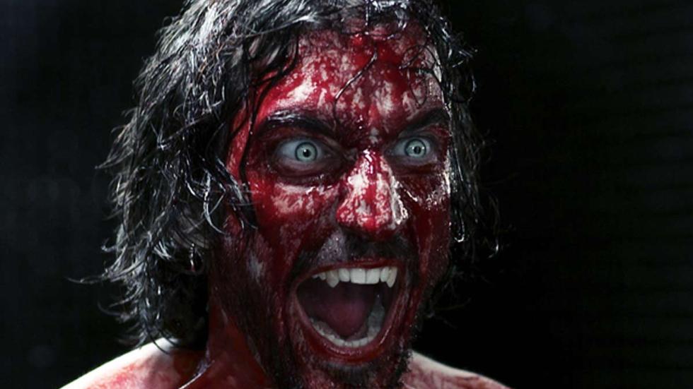 Chimères bloodied face vampire with piercing blue eyes