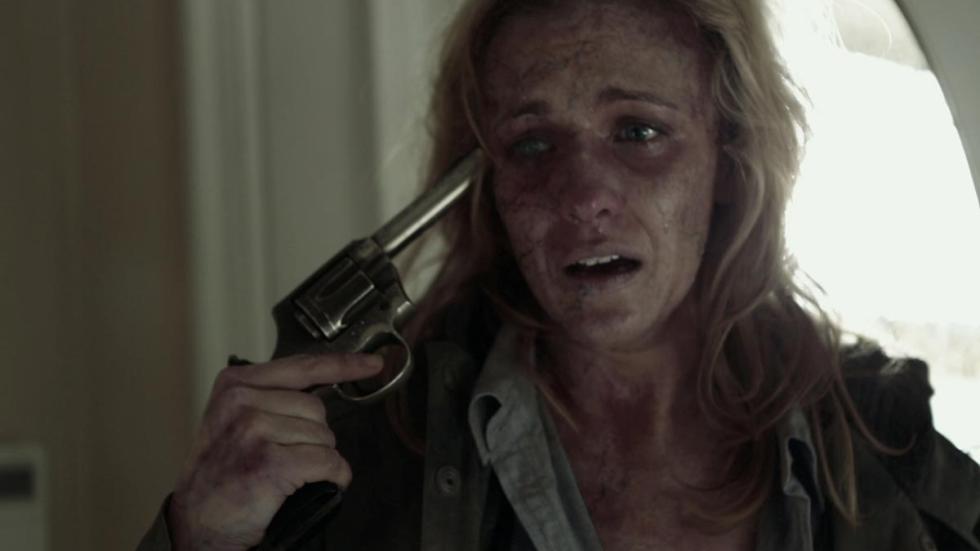 Turned woman holds a gun to her head.