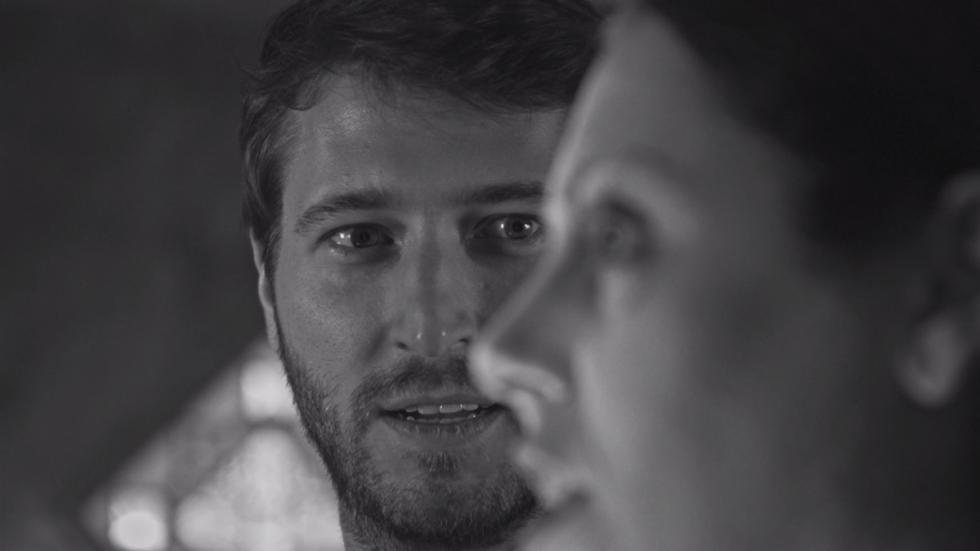 A Ghost Waits man looking at a woman's profile