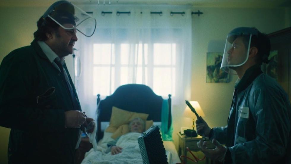 The Dead Collectors film still men standing near a woman in bed