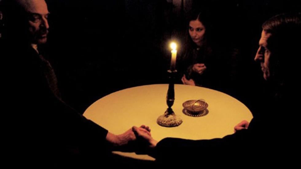 Seance people sitting around a table performing a seance