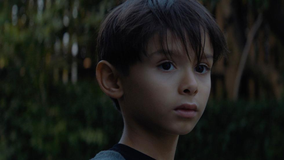 Young boy looks on