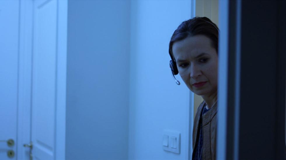 Alone woman listens on a phone headset