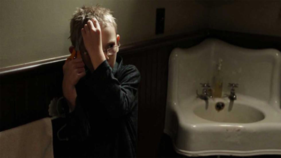 Shhh young boy hides in the bathroom