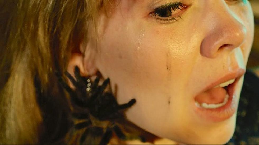 The Candle film still scared woman with a spider on her face