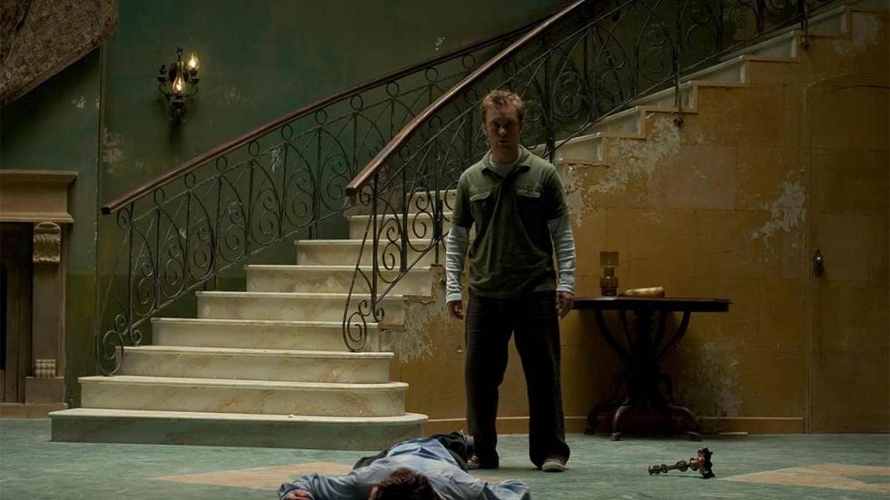 Spirit Trap man looks at dead person laying on the floor
