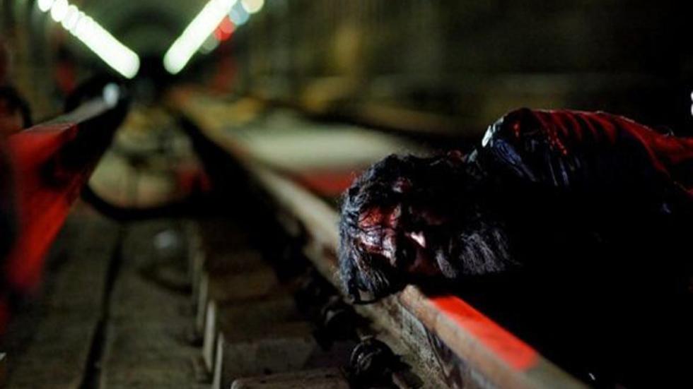 Stag Night bloodied person on the subway tracks