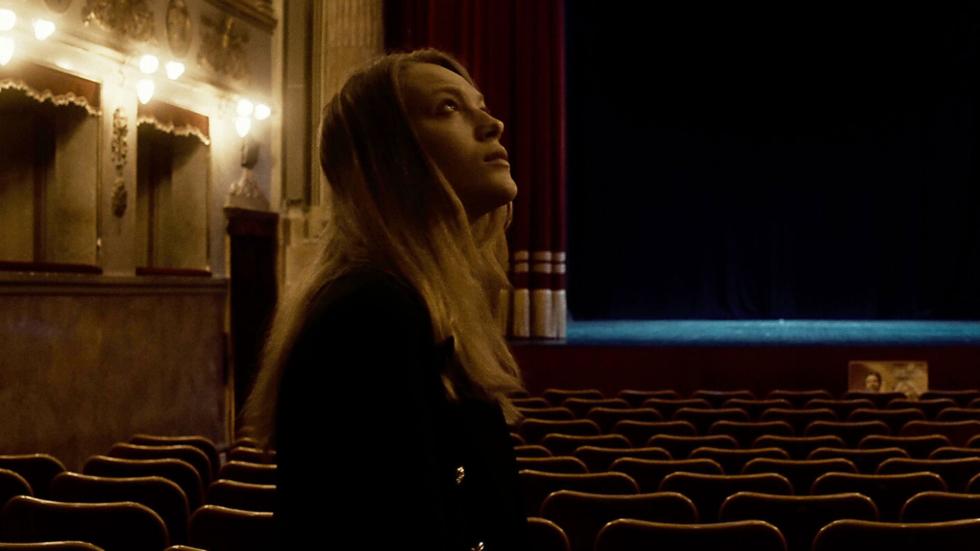 Laura looks up at the huge auditorium