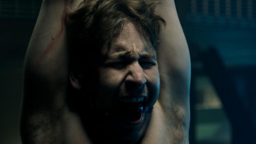 To Catch a Mouse film still man hung up being tortured