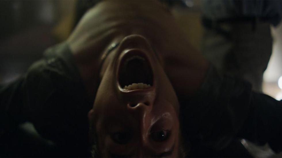 Pledge film still shirtless man on his back screaming
