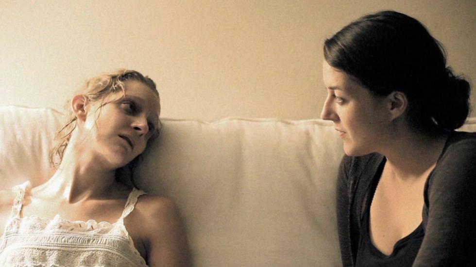 Sulfuric sick woman speaks with another woman from her bed