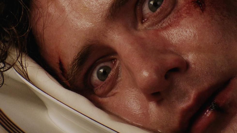 The Appointment film still man looking scared laying on pillow
